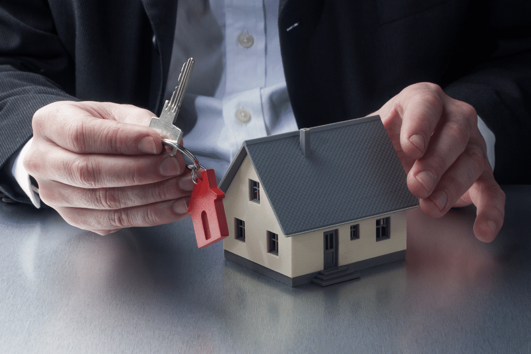 Person with key and house model