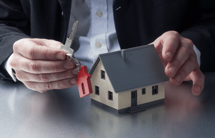 Person with key and house model
